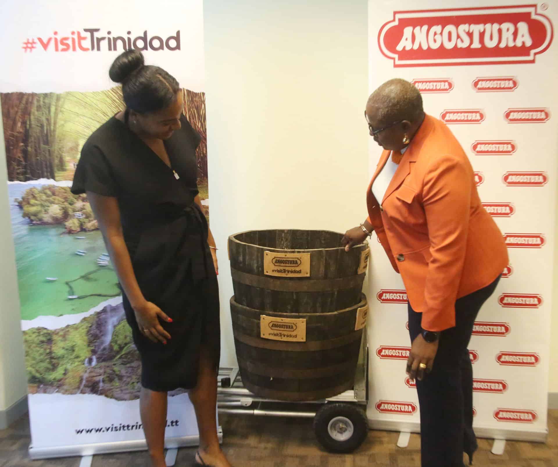 Angostura executive manager marketing Sophie Charles-Barber, left and Tourism Trinidad Ltd CEO Carla Cupid look at repurposed rum barrels during the handing over at the International Waterfront Centre, Port-of-Spain. Photo Credit: Trinidad Guardian Newspaper